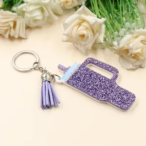 Macro view of purple glitter acrylic cup-shaped keychain with tassel