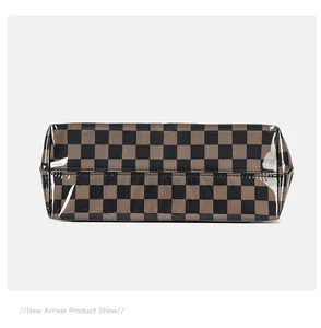 Detailed view of the brown checkerboard tote bag bottom with waterproof PVC finish
