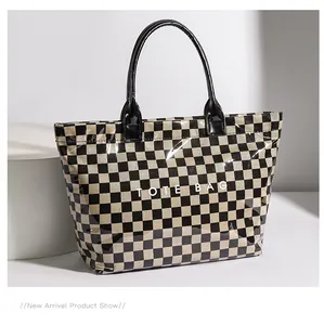 Detailed studio shot of a vintage checkerboard tote bag with clear PVC outer layer