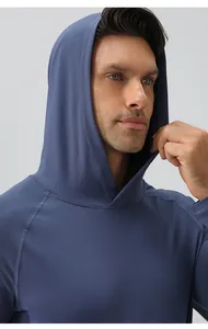 Detailed view of a men's blue hooded athletic top made of moisture-wicking fabric