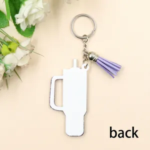Detailed back view of white tumbler shaped acrylic keychain with purple decorative tassel