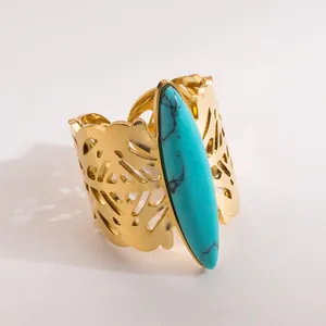Detail of vintage gold stainless steel wide ring with marquise turquoise stone