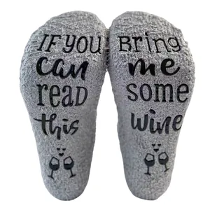 Detailed close-up of grey coral fleece socks featuring non-slip wine glass print sole
