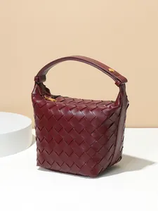 Handmade burgundy woven handbag with large capacity and a stylish handle design