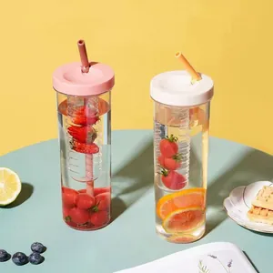Macro view of transparent fruit infuser tumblers with fresh fruit and soft lighting