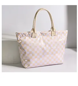 Close-up of checkerboard PVC tote bag with stylish top handle straps