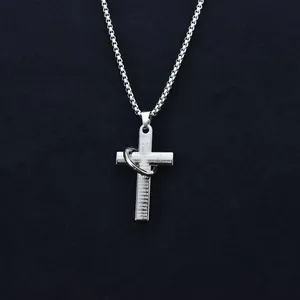 Detailed macro shot of stainless steel cross pendant with engraved Spanish prayer text