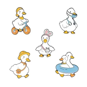 Set of cute white duck enamel pins in various cartoon outfits on white background