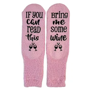 Cozy pink coral fleece socks featuring 'Bring me some wine' anti-slip rubber slogan