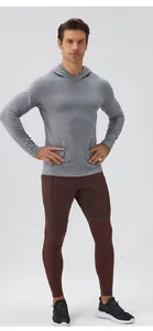 Full-body view of men's grey sports hoodie and maroon training leggings on model.