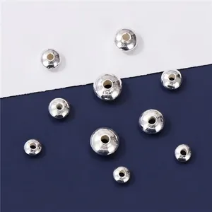 Close-up macro view of polished silver-plated round spacer beads for DIY jewelry making