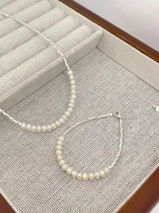 Detail view of s925 silver natural pearl necklace and bracelet set in jewelry box.