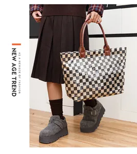 Close-up of retro checkerboard PVC tote bag with leather handles in a fashion setting