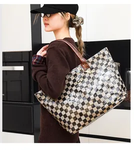 Stylish checkered transparent PVC tote bag carried by a model in a kitchen.