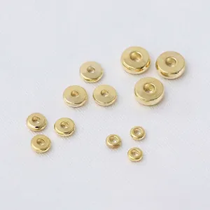 Macro view of polished 18k gold plated wheel spacer beads for jewelry making