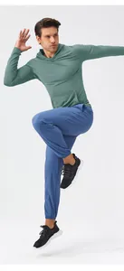 Close-up of a man wearing a slim-fit green hooded moisture-wicking sports top.