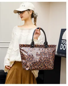 Asian model holding a stylish leopard print PVC tote bag with large capacity for commuting.