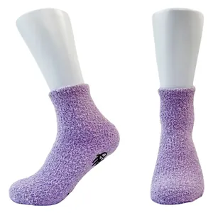 Thickened purple coral fleece floor socks with black anti-slip grip dots on sole.