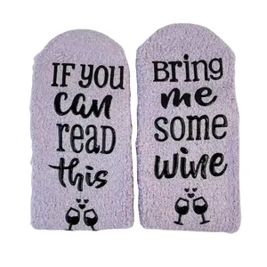 Bottom view of purple thick coral fleece floor socks with 'Bring me some wine' text