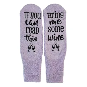 Close-up of anti-slip 'Bring Me Some Wine' text on lavender coral fleece floor socks