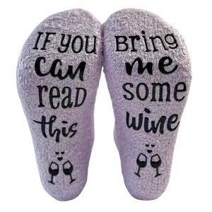 Cozy lavender coral fleece socks with funny non-slip wine quote text on soles.