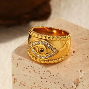 Close-up detail of a vintage gold-plated stainless steel evil eye ring with crystal pavé