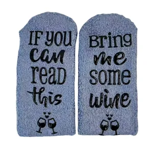 Funny fuzzy coral fleece wine socks featuring non-slip rubber lettering on soles