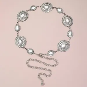 Detailed macro view of vintage silver waist chain with white turquoise floral links
