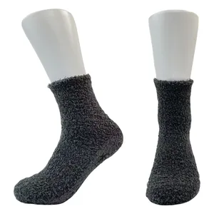 Close-up detail of thick dark grey coral fleece floor socks featuring non-slip dot soles