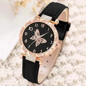 Detailed view of women's quartz watch with butterfly dial and rhinestone case.
