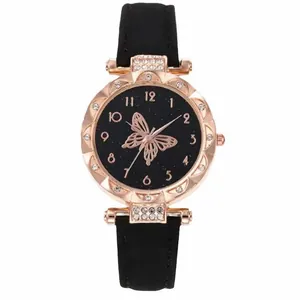 Detailed view of women's quartz watch with butterfly pattern dial and rhinestone accents