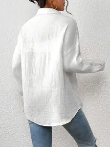 Back view of white long-sleeve batwing shirt with textured cotton fabric