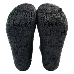Detailed view of thickened coral fleece socks with wine themed anti-slip rubber soles