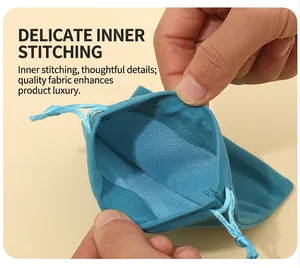 Close-up of the fine interior stitching on a teal velvet drawstring pouch detail