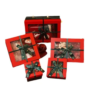 Set of red Christmas gift boxes with clear windows and green Merry Christmas ribbons