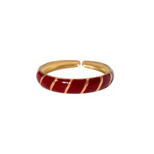 Close-up detail of a retro adjustable stainless steel ring with red enamel diagonal stripes