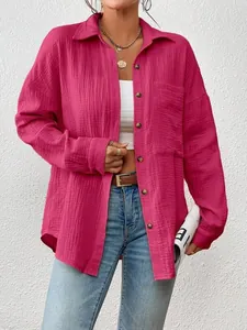 Close-up of a fuchsia textured button-down shirt showing its drop shoulder detail