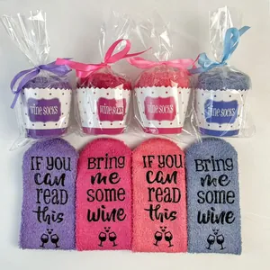 Set of 4 cozy coral fleece wine socks in cupcake gift packaging with funny quotes.