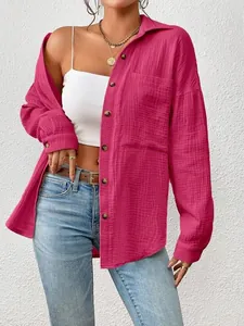 Stylish fuchsia button-down shirt featuring long sleeves and textured gauzy fabric