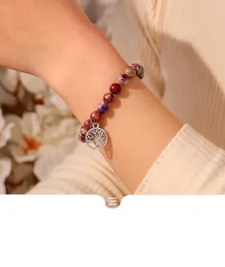 Detail view of 8mm colorful natural stone beaded bracelet with Tree of Life charm