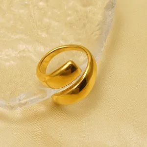 Close-up of a minimalist stainless steel gold plated open ring with mirror finish.