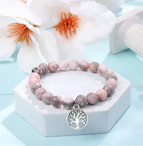 Close-up detail of natural stone beaded bracelet featuring a vintage silver Tree of Life charm