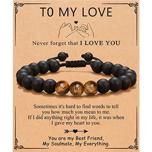 Matte black bead bracelet with 3 tiger eye stones on gift card for men.