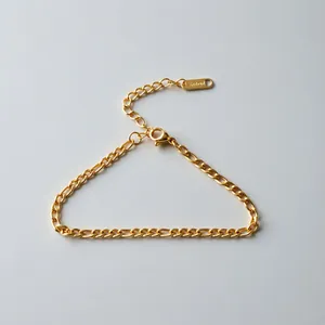 Detail of stainless steel gold Cuban link chain bracelet with tag