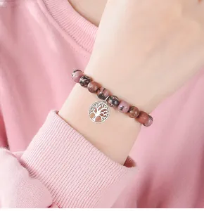 Close-up of 8mm natural stone beaded bracelet with a silver Tree of Life charm.