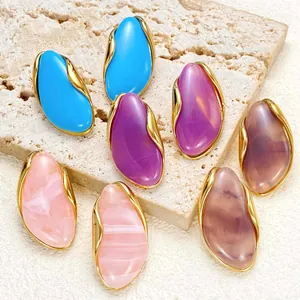 Detailed view of irregular colorful resin stud earrings with elegant gold-toned metal rims