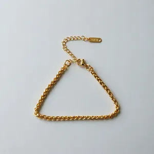 Close-up of gold stainless steel Cuban link bracelet with lobster clasp.