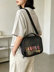 Black transparent medal display crossbody bag shown worn by a model in a clean indoor setting