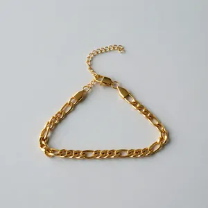 High-quality macro shot of a golden stainless steel Figaro chain bracelet detail