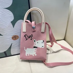 Detailed view of pink knitted mini tote bag featuring cute dog embroidery and strap
